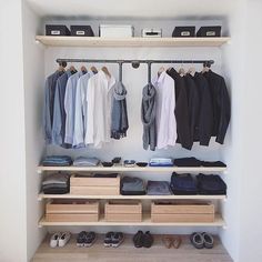 an image of a closet with clothes and shoes on the shelves in front of it