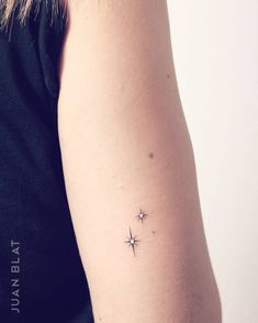 a woman with a small star tattoo on her arm