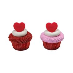 two cupcakes with red and white frosting on top, one topped with a heart