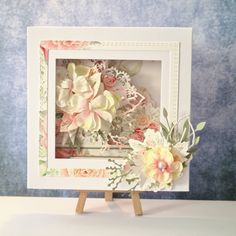 a small white frame with flowers on it