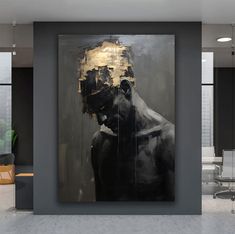 a large black and gold painting in an office