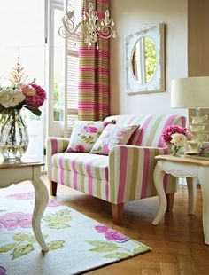 a living room filled with furniture and flowers