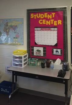 a desk with a bulletin board on it