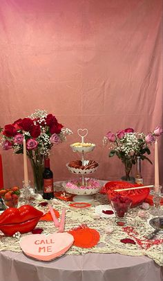 a table topped with lots of red and pink flowers