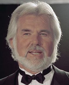 an older man wearing a tuxedo and bow tie