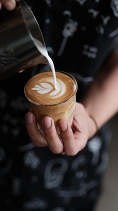 a person is pouring milk into a cup