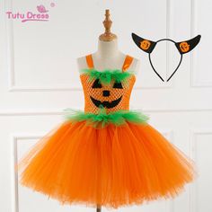 an orange and green tutu dress on a mannequin