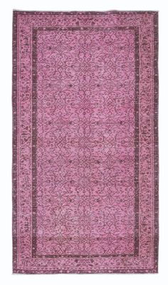 a pink rug with an intricate design on the bottom and sides, in different colors