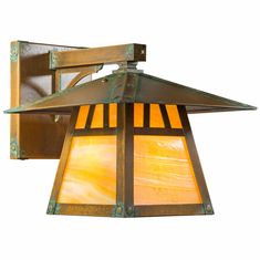 a light fixture with an orange glass shade on the front and back side of it