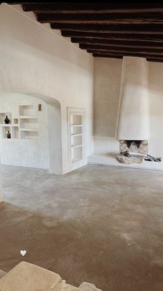 an empty room with two fireplaces in it