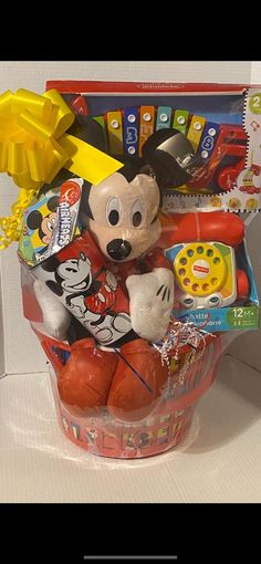 a toy mickey mouse in a basket with other toys