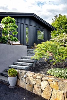 a black house with stone steps leading up to it