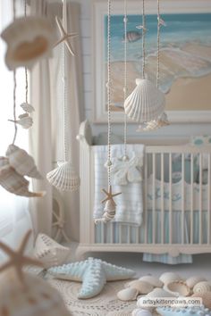 a baby crib with seashells hanging from it