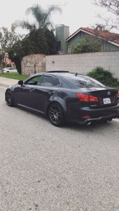 a black car is parked on the street