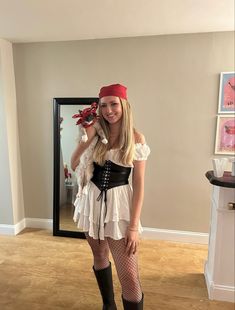 a woman in a pirate costume posing for the camera