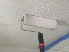 a paint roller is hanging from the ceiling