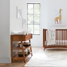 a baby's room with a wooden crib and white rug