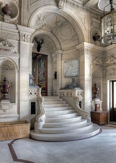 an ornately decorated entryway with white marble stairs