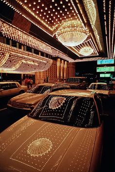 cars parked in a parking lot covered with lights