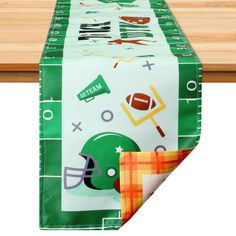 a football themed table runner on top of a wooden table