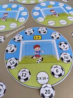 a table topped with lots of soccer themed plates and placemats on top of a table