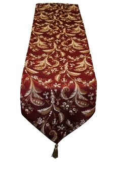 a red and gold table runner with an ornate design on it's side,