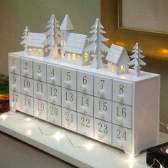 a lighted calendar with houses and trees on it