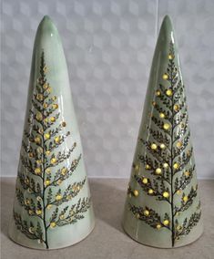 two ceramic trees with gold leaves on them