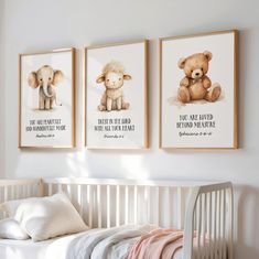 three framed pictures hang on the wall above a crib in a white nursery room