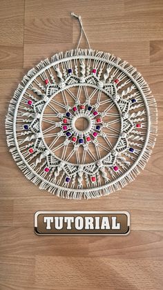 a wooden floor with a white circular object on it's side and the words, how to make a wall hanging