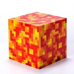 an orange and red cube with yellow squares on the top, sitting in front of a white background