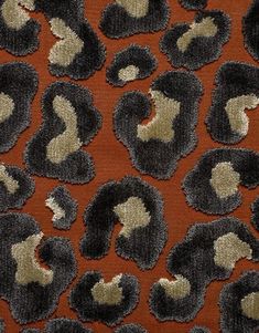 an orange and black animal print fabric with white spots on it's back side