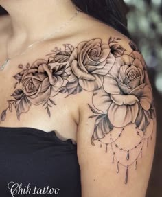 a woman's shoulder with roses on it