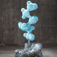 there is a sculpture made out of blue gummy bears on top of a rock