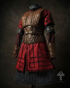 a red and black costume with leather accents on it's chest, standing in front of a dark background