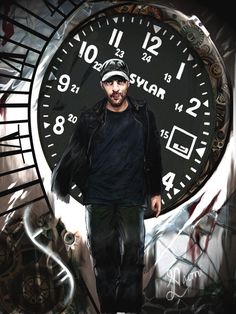 a man standing in front of a large clock with graffiti on it's face