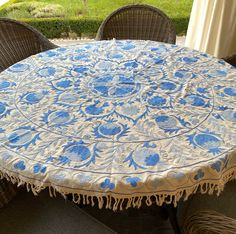 a blue and white table cloth sitting on top of a wicker chair