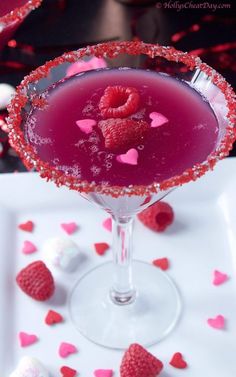 a raspberry martini is garnished with fresh raspberries for valentine's day