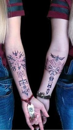 two girls with matching tattoos holding hands