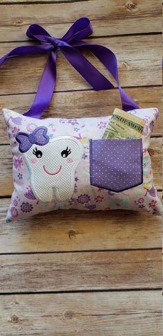 a pillow with a purple bow on it