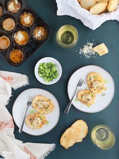 two plates with food on them next to muffins and other foodstuffs