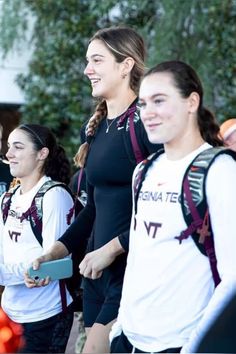 some girls are standing together and smiling for the camera