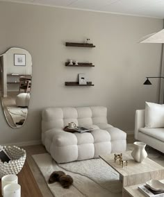 a living room filled with furniture and a large mirror