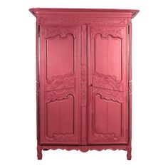 a pink armoire with ornate carvings on the top and bottom panel, against a white background