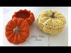 two crocheted pumpkins sitting next to each other