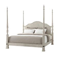 a bed with four posts and white sheets