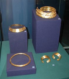 three different types of gold jewelry on display