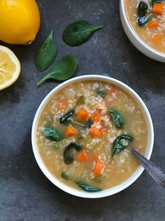 two white bowls filled with soup next to lemons