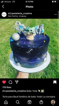 an image of a blue cake with stars and planets on it