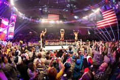 a large group of people standing in front of a wrestling ring